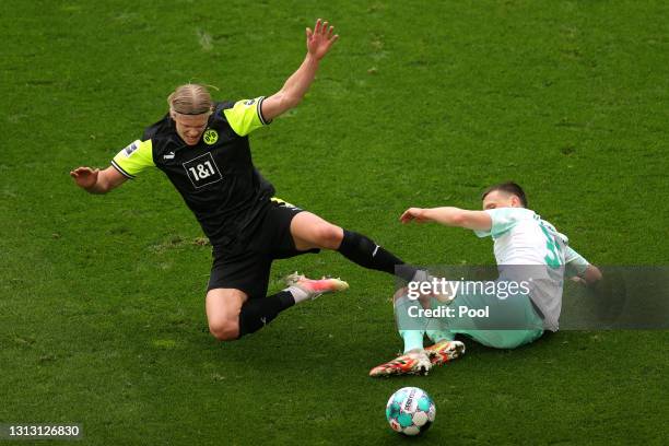 Erling Haaland of Borussia Dortmund is challenged by Maximilian Eggestein of Werder Bremen during the Bundesliga match between Borussia Dortmund and...