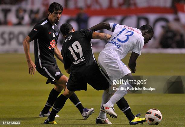 Neicer Reascos of Liga Deportiva Universitaria struggles for the ball with Robin Ramirez of Libertad during a match as part of Bridgestone Cup...