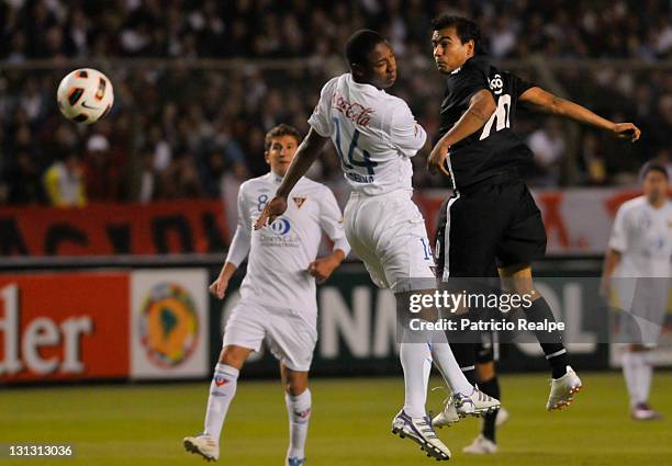 Diego Calderon of Liga Deportiva Universitaria struggles for the ball with Manuel Maciel of Libertad during a match as part of Copa Bridgestone...