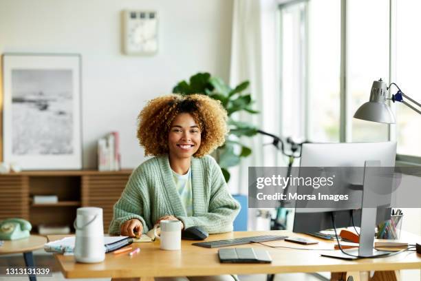 confident female freelancer at home office - portrait of man smiling black jumper stock-fotos und bilder