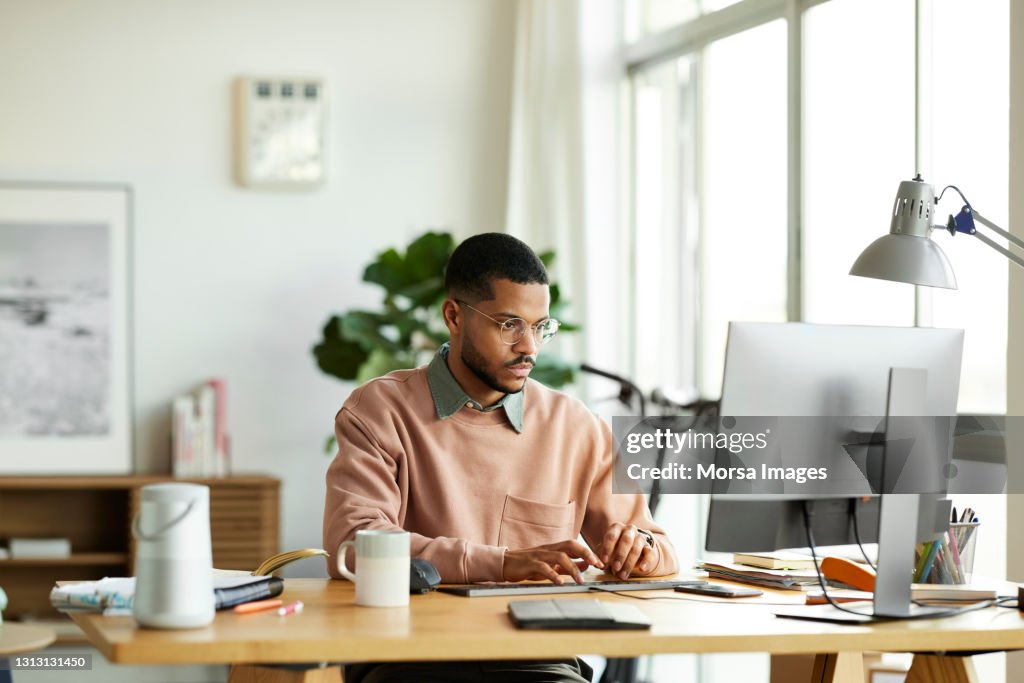 Freelancer Using Computer At Home Office