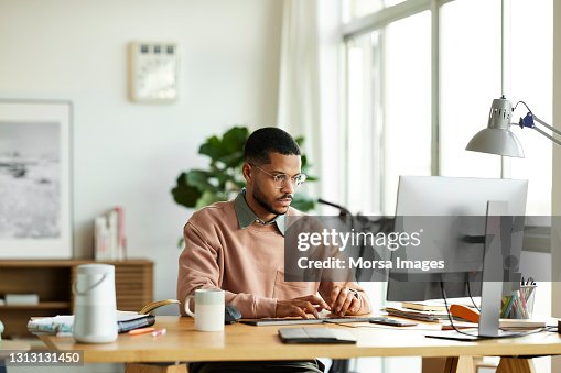 Freelancer Using Computer At Home Office Freelancer Using Computer At Home Office