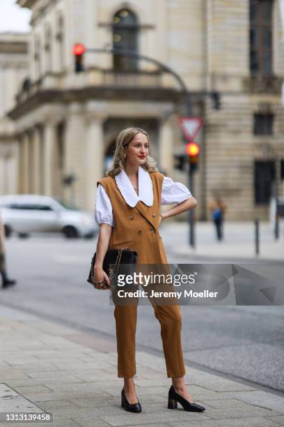 Louisa Theresa Grass wearing white Soft Rebels blouse and brown suit, Tamaris heels and Chanel leather bag on April 15, 2021 in Hamburg, Germany.