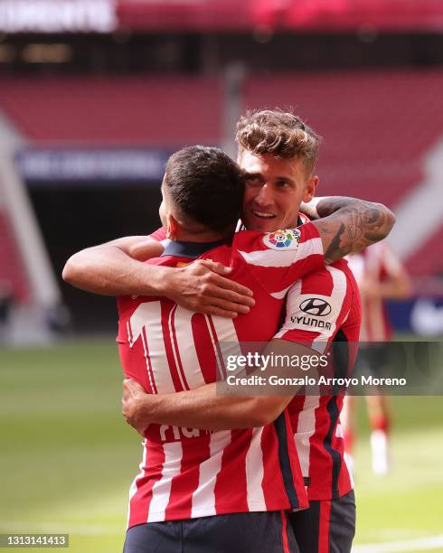 Marcos Llorente of Atletico de Madrid celebrates scoring their fourth goal with teammate Angel Martin Correa during the La Liga Santander match...