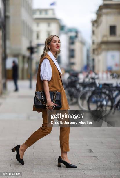 Louisa Theresa Grass wearing white Soft Rebels blouse and brown suit, Tamaris heels and Chanel leather bag on April 15, 2021 in Hamburg, Germany.