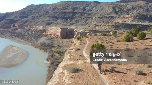 mountain biker follows desert pathway in the morning - colorado river stock pictures, royalty-free photos & images