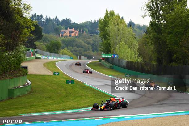 Max Verstappen of the Netherlands driving the Red Bull Racing RB16B Honda leads Lando Norris of Great Britain driving the McLaren F1 Team MCL35M...