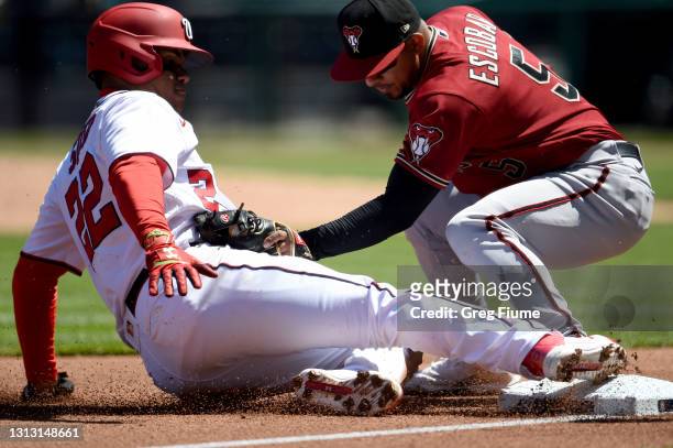 Juan Soto of the Washington Nationals is tagged out at third base in the first inning by Eduardo Escobar of the Arizona Diamondbacks at Nationals...