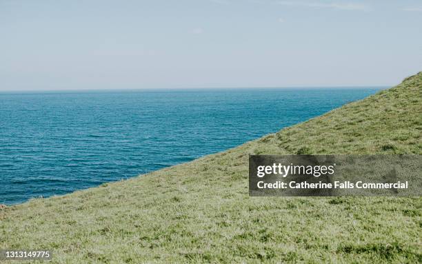 simple image of horizon meeting sloped hill - slanted stock pictures, royalty-free photos & images