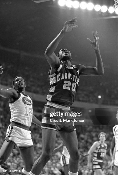 Cleveland Cavaliers forward Campy Russell goes up for a rebound in front of Denver Nuggets guard Ted McClain during an NBA basketball game at...