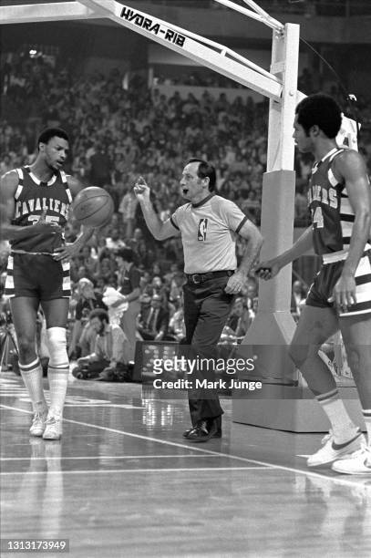 Referee Norm Drucker is sandwiched between Cleveland Cavaliers players Jim Cleamons and Austin Carr during an NBA basketball game against the Denver...