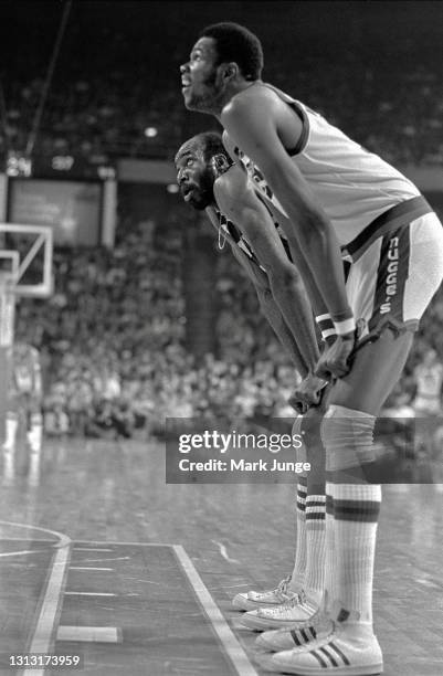 Cleveland Cavaliers center Nate Thurmond and Denver Nuggets center Marvin Webster look up toward the basket during a free throw attempt in an NBA...