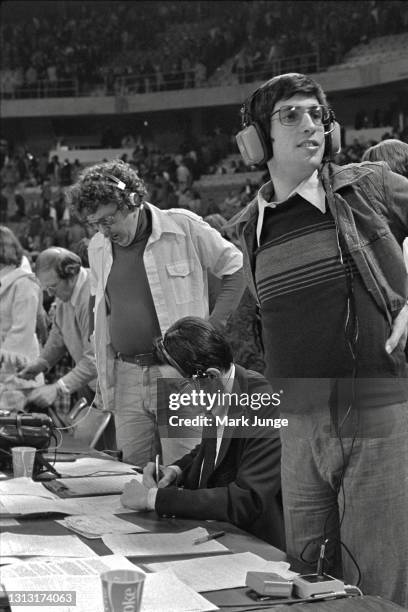 Denver Nuggets announcer Al Albert stands next to co-broadcaster Bob Martin behind the scorer’s table during a timeout in an NBA basketball game...