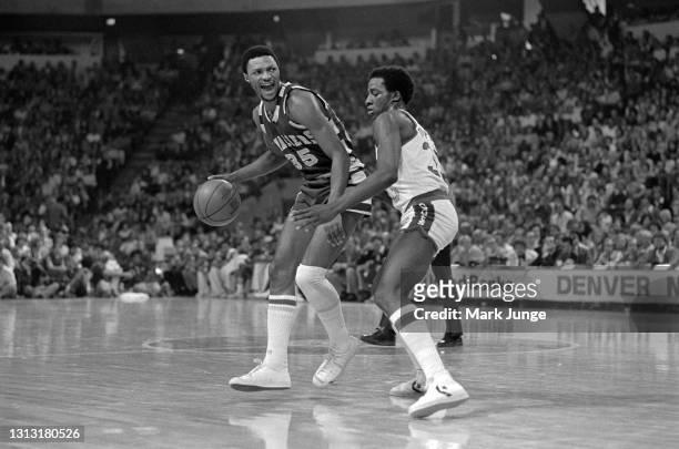 Cleveland Cavaliers guard Jim Cleamons dribbles the ball with his back to the defender, Denver Nuggets forward David Thompson, during an NBA...