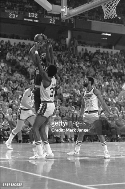 Cleveland Cavaliers forward Campy Russell goes up for a jump shot against Denver Nuggets forward Paul Silas as Nuggets guard Fatty Taylor watches in...