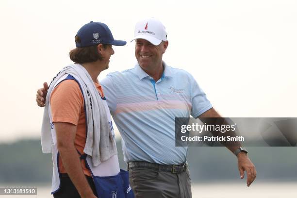 Stewart Cink of the United States celebrate with his caddie and son, Reagan Cink, on the 18th green after winning the RBC Heritage on April 18, 2021...