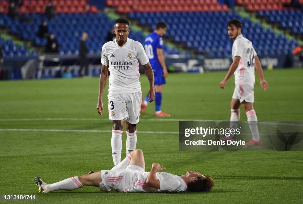 Eder Militao of Real Madrid comes to the aid of team mate Alvaro Odriozola during the La Liga Santander match between Getafe CF and Real Madrid at...