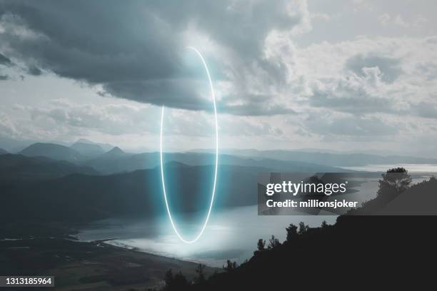 mountain road landscape, stunning circle shape made with neon light inside the clouds - event horizon stock pictures, royalty-free photos & images