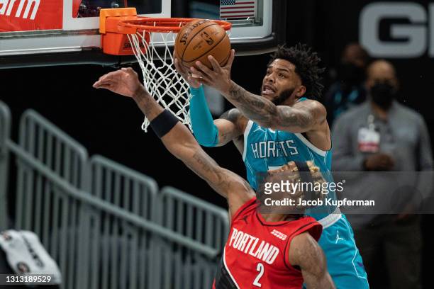 Miles Bridges of the Charlotte Hornets catches a pass over Rondae Hollis-Jefferson of the Portland Trail Blazers in the first quarter at Spectrum...