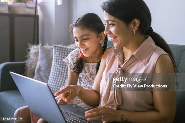 mother and daughter using laptop computer at home - parent computer stock pictures, royalty-free photos & images