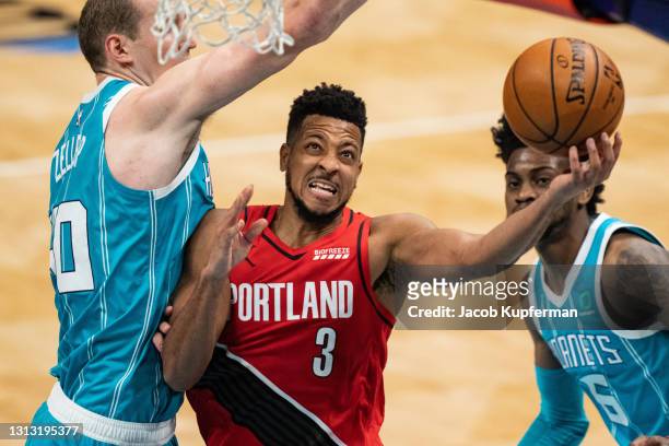 McCollum of the Portland Trail Blazers drives to the basket while guarded by Cody Zeller of the Charlotte Hornets in the second quarter at Spectrum...