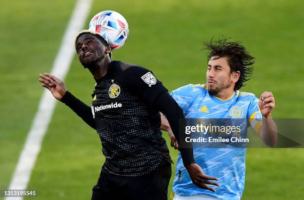 Gyasi Zerdes of Columbus Crew SC and Alejandro Bedoya of Philadelphia Union jump to head the ball in the second half during their game at the...