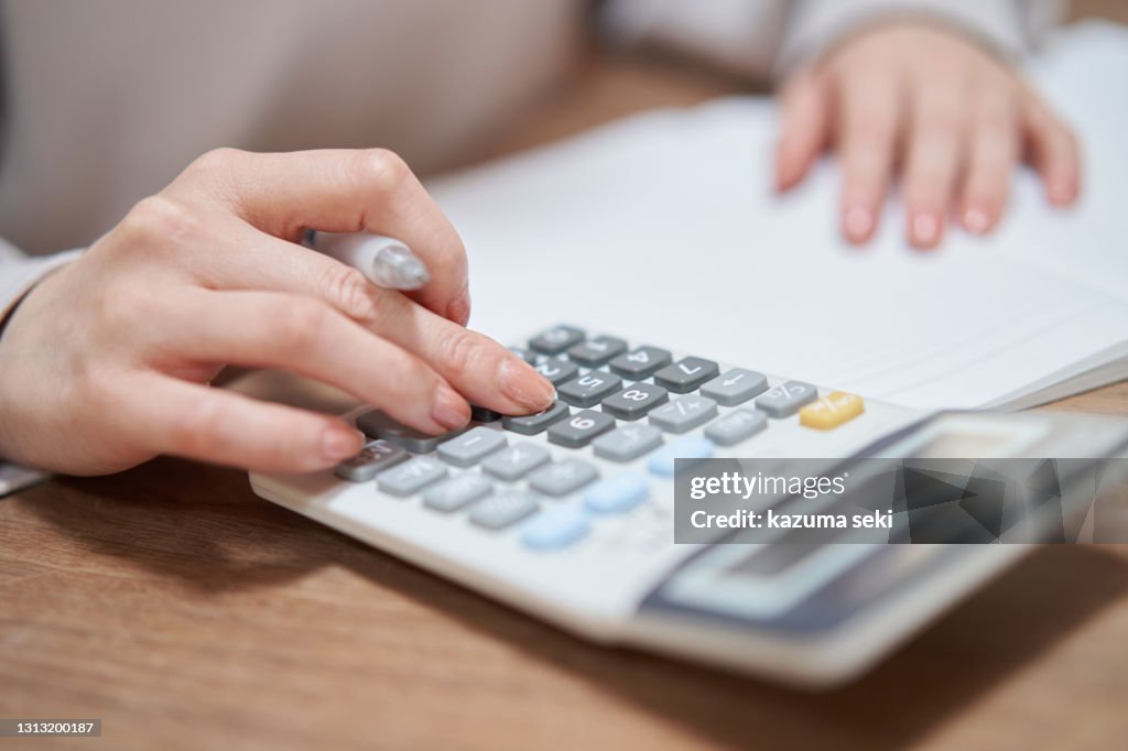 Asian woman reviewing household budget