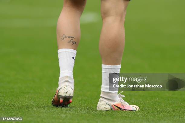 Hakan Calhanoglu of AC Milan's calf is seen bearing ta tattoo with the names of his former wife Sinem and daughter Liya during the warm up prior to...