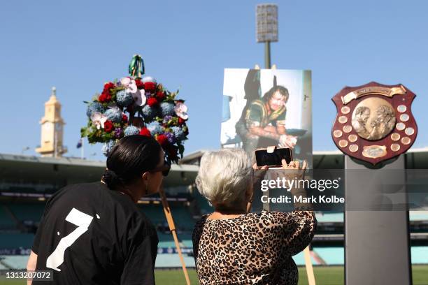 Tommy Raudonikis' wife Trish Brown takes photos of the Winfield State of Origin trophy during the Tommy Raudonikis Memorial Service at the Sydney...