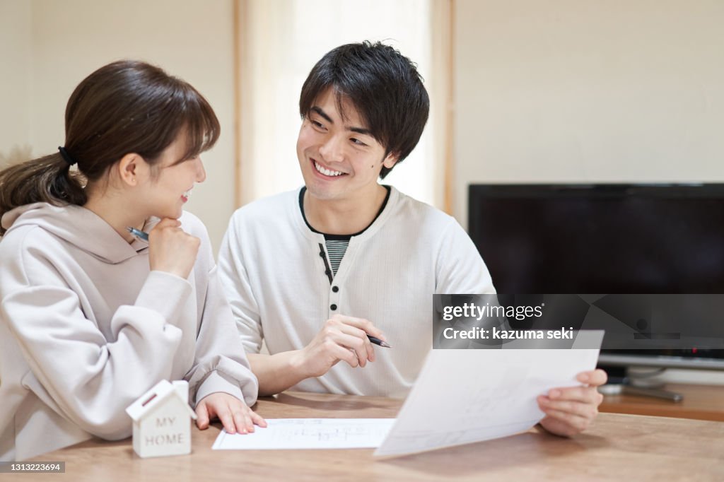 Asian couple thinking about buying a home