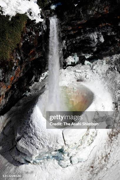 In this aerial image, water falls into a deep ice basin at Hyakuyojo no Taki waterfall on Mount Hakusan on April 15, 2021 in Hakusan, Ishikawa,...