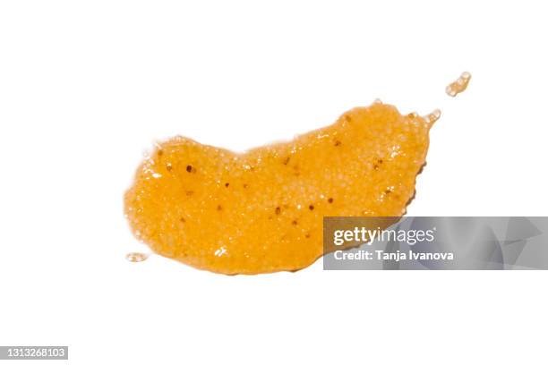 textured smear of orange skin scrub isolated on white background. flat lay, top view, copy space. - exfoliation stock pictures, royalty-free photos & images