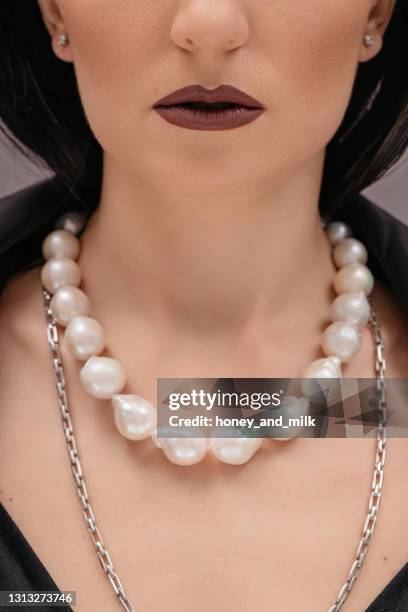 portrait of a beautiful woman wearing a pearl necklace - pearl necklace stock pictures, royalty-free photos & images