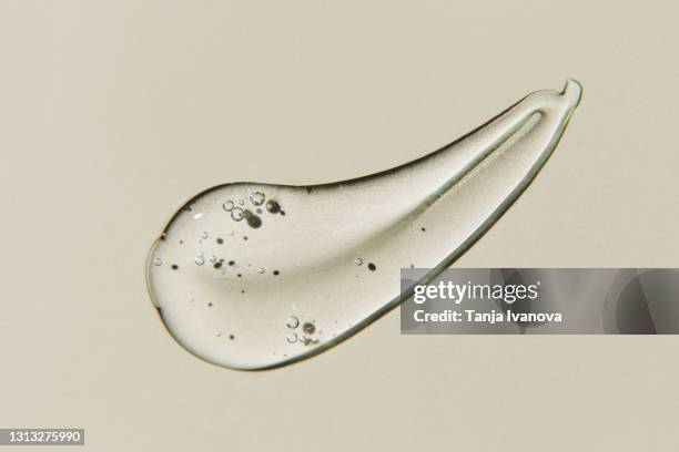 transparent smear of gel on beige background. liquid hyaluronic acid gel. flat lay, top view, copy space - gel de cabelo imagens e fotografias de stock