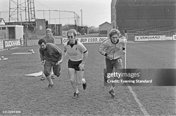 British singer-songwriter Elton John and singer Rod Stewart training at Vicarage Road in Watford, 7th November 1973. Elton John is vice-president of...