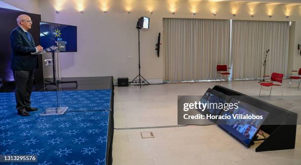 Journalists are seen on screen as the attend the Portuguese Foreign Minister Augusto Santos Silva press conference at the end of his participation in...