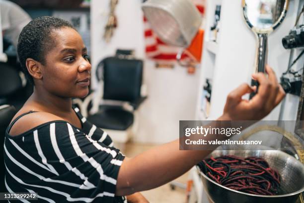 beautiful afro women taking selfie of her new hairstyle, after cutting her dreadlocks in hair salon - open hair selfie stock pictures, royalty-free photos & images