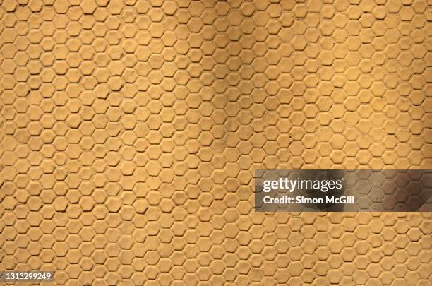 exterior wall of pale orange yellow painted hexagon tiles - abundance tiles stock pictures, royalty-free photos & images