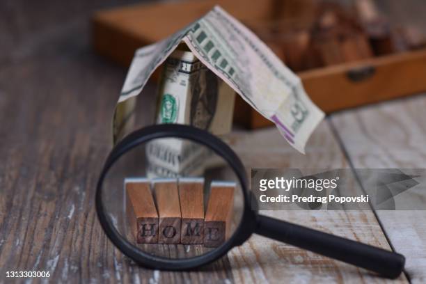 home under magnifying glass as business , finance and housing concept - under value stock pictures, royalty-free photos & images