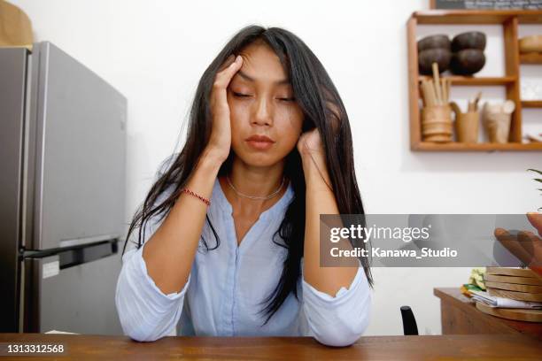 indonesian woman suffering from migraine - the morning after stock pictures, royalty-free photos & images