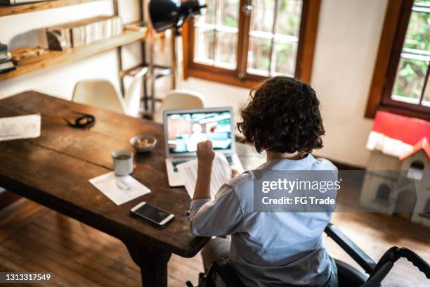 disability woman doing a virtual business meeting at home - virtual presentation stock pictures, royalty-free photos & images