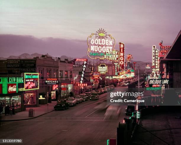 1940s Golden Nugget And Other Casinos Hotels Shops Neon Signs Along Strip Fremont Street At Twilight Las Vegas Nevada USA.