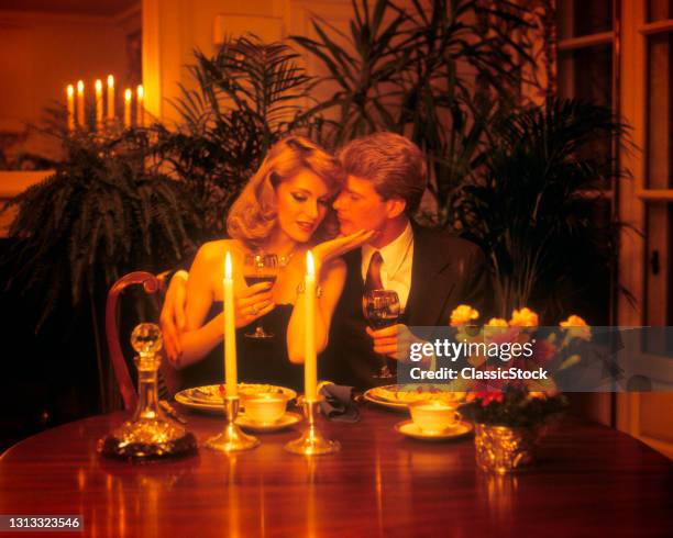 1970s 1980s Couple Sharing A Romantic Candlelight Dinner Woman Touching Man's Face.