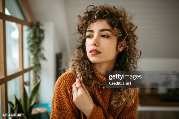 portrait of a beautiful young woman with a curly hair. - naturligt hår bildbanksfoton och bilder