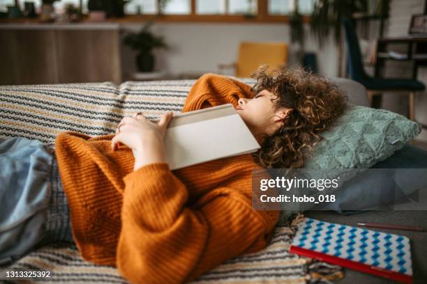 afternoon napping - teenager reading a book stock pictures, royalty-free photos & images