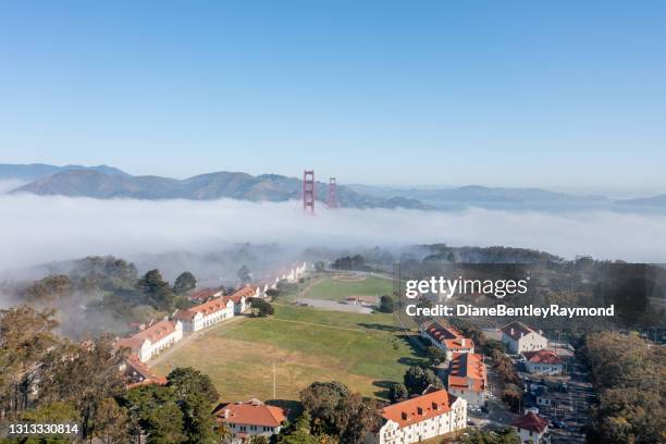 aerial view of golden gate bridge in the fog - the presidio stock pictures, royalty-free photos & images