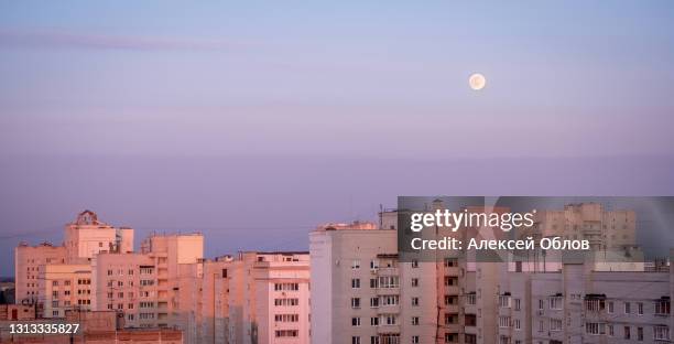 full moon over the houses of the city - silver moon pictures stock pictures, royalty-free photos & images