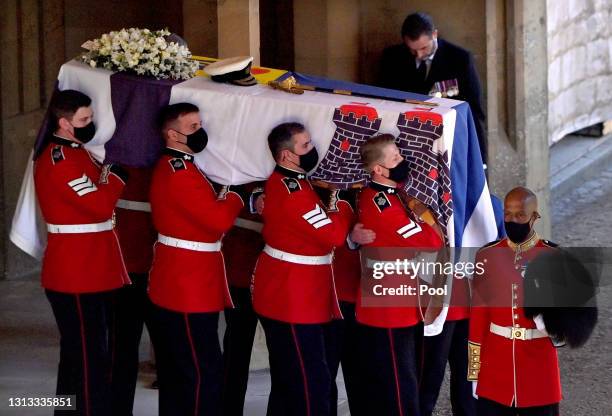 Bearer Party of Grenadier Guards carry Prince Philip, Duke of Edinburgh's coffin out of the State Entrance of Windsor Castle ahead of his funeral...