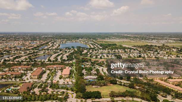 aerial view of housing in wellington, florida west part of west palm beach, florida during covid-19 in april of 2021 - west palm beach florida stock pictures, royalty-free photos & images