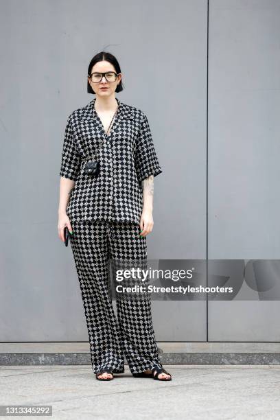 Influencer Maria Barteczko wearing a black and white silk printed short sleeve shirt by Arket, black and white silk printed wide leg pyjama pants by...